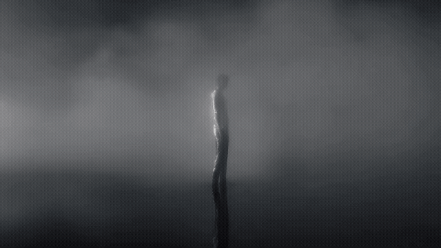 Gen-4_5 A solitary figure, their form indistinct and shimmering, stands at the edge of an impossibly still, reflective body of water The entire scene is enveloped in a thick, luminous fog that diffus.mp4.gif