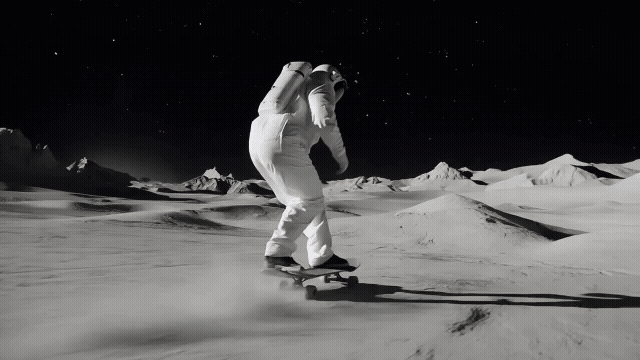 Gen-4_5 A handheld low angle tracking shot, with low contrast and fast-paced motion, follows a skilled astronaut skateboarder on a moon landscape their movements blur against the soft glow of the dar.mp4.gif