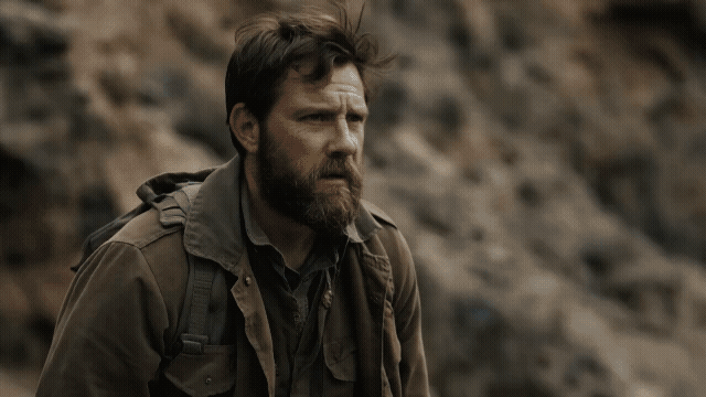 Gen-4_5 The camera performs a smooth pull back from a lone explorer, initially focused tightly on their determined face, as they take a deep breath before sprinting to dynamically leap across a chasm.mp4.gif