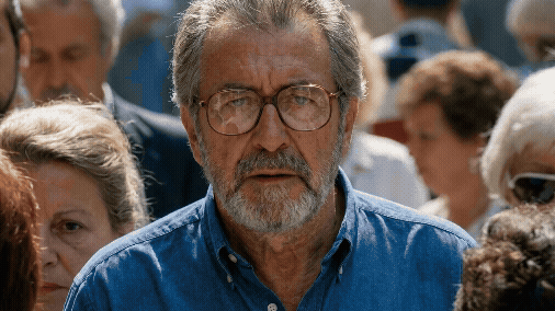 Adobe Express - Gen-4_5 hand held camera the man stands still as the crowd moves around her, he starting yelling as the camera slowly zooms outHandheld documentary film style Natural camera shake Raw indie aestheti.gif