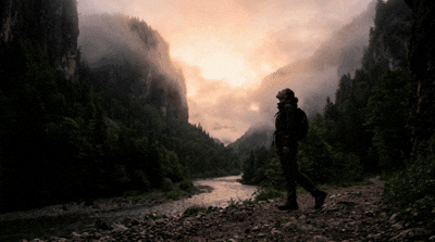 Scene Builder - A lone figure walks through a foggy canyon at dawn.gif